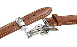 Close-up of a metallic butterfly clasp integrated with a textured brown leather wristband, highlighting the precision-engineered dual-fold closure.