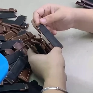 Final quality control check on assembled watch bands, testing hardware assembly accuracy and functionality prior to shipment.