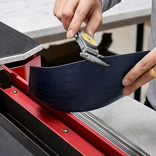 Precision measurement of leather thickness using a digital caliper, guaranteeing dimensional accuracy and physical compliance before production.